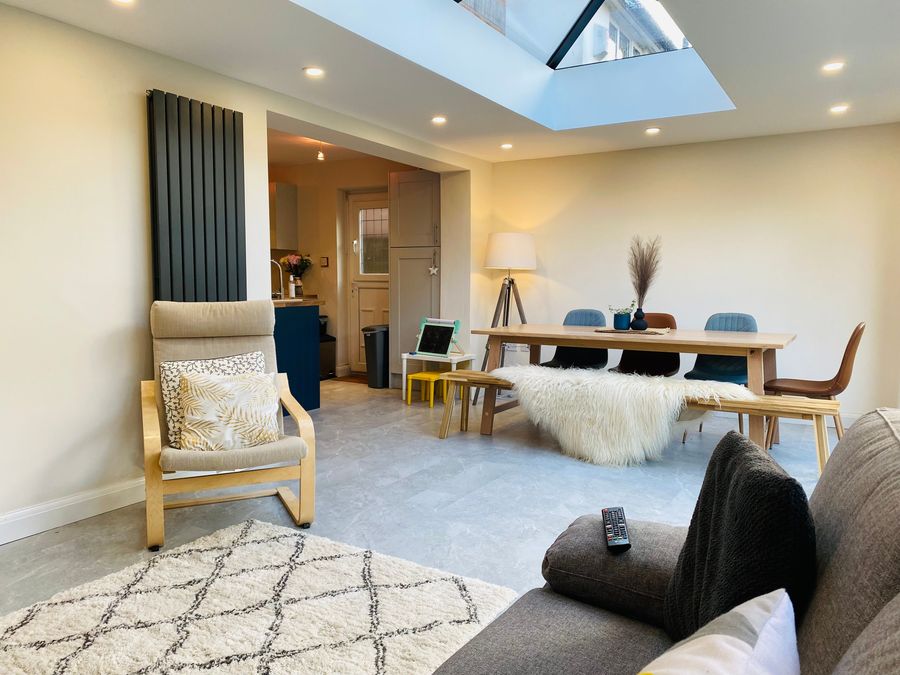 Furnished living room inside a modular extension with roof lantern above