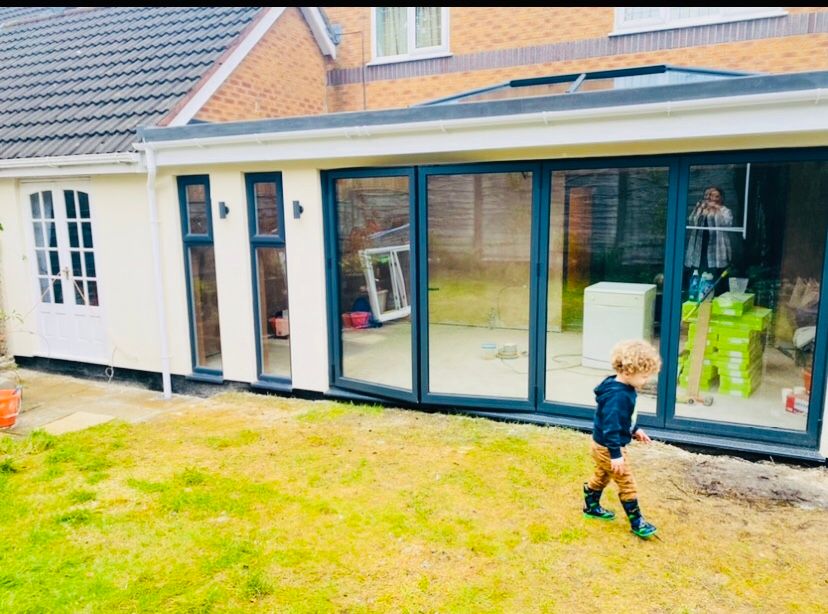 Completed rear extension with full-width bifold doors opening onto the garden